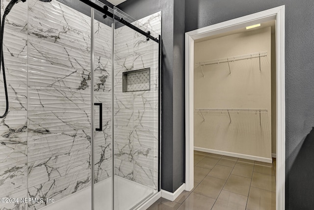 bathroom with tile patterned flooring and a shower with shower door