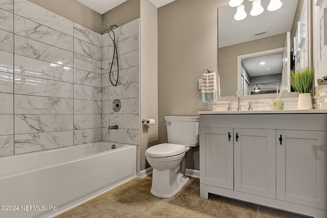 full bathroom with tile patterned floors, toilet, vanity, and tiled shower / bath