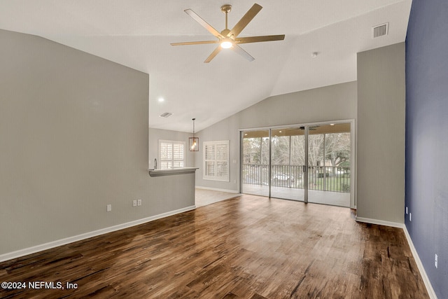 unfurnished living room featuring ceiling fan, wood-type flooring, and vaulted ceiling