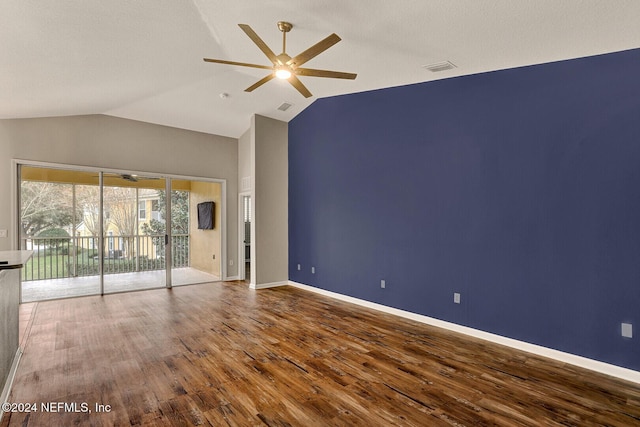 empty room with ceiling fan, lofted ceiling, and hardwood / wood-style flooring