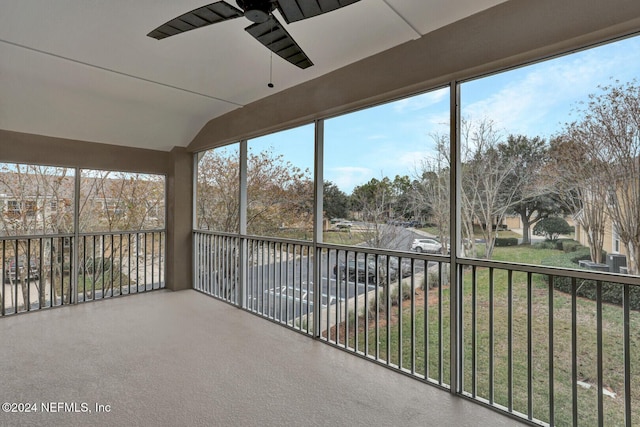 unfurnished sunroom with ceiling fan and lofted ceiling