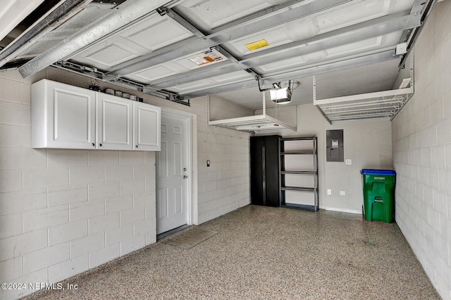 garage with a garage door opener and electric panel