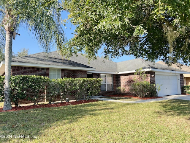 single story home featuring a front lawn and a garage