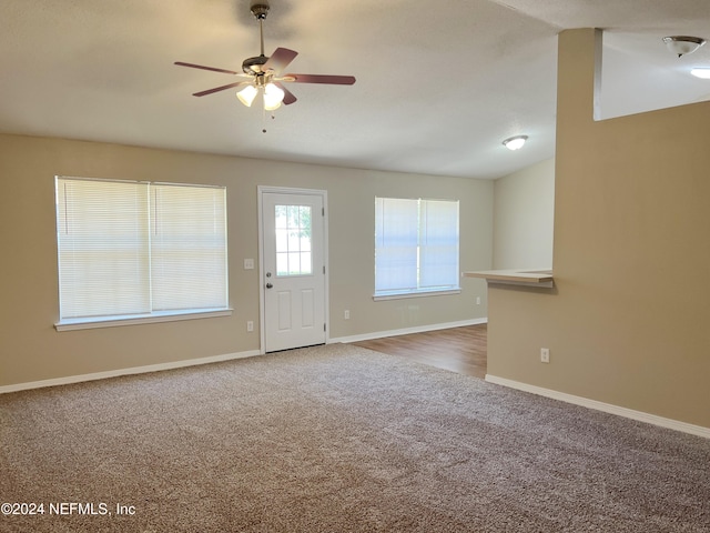 unfurnished living room with carpet floors and ceiling fan