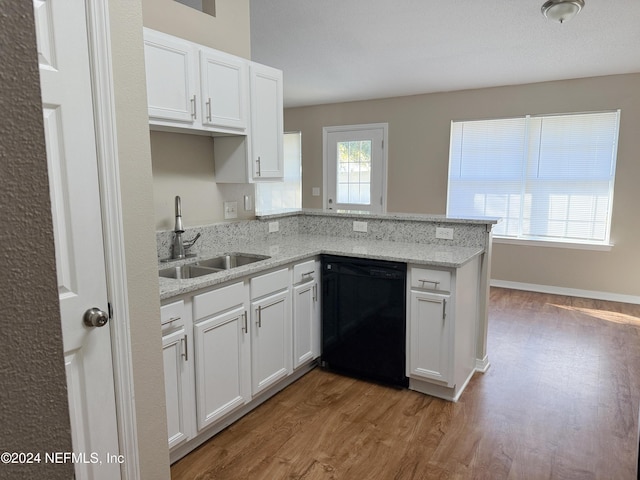 kitchen featuring kitchen peninsula, white cabinetry, dishwasher, and sink