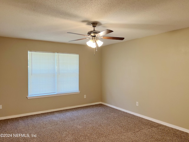 carpeted empty room featuring a textured ceiling and ceiling fan