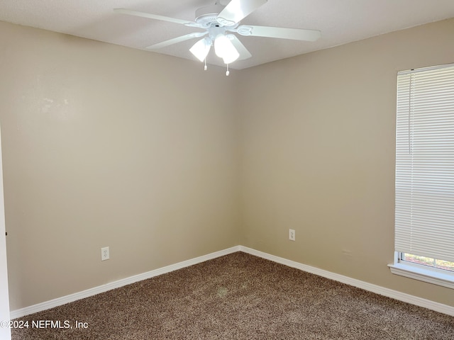 carpeted empty room featuring ceiling fan