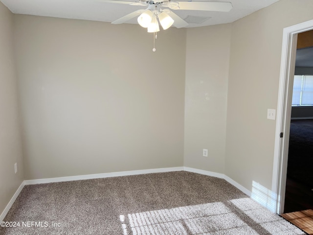 empty room with ceiling fan and carpet