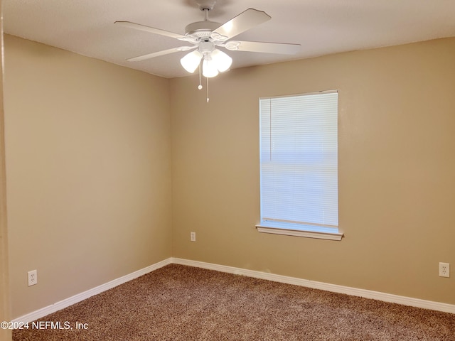 carpeted empty room featuring ceiling fan