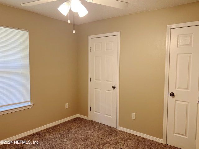 unfurnished bedroom featuring carpet and ceiling fan