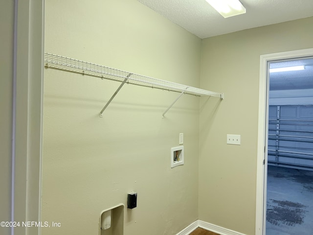 washroom featuring a textured ceiling and hookup for a washing machine