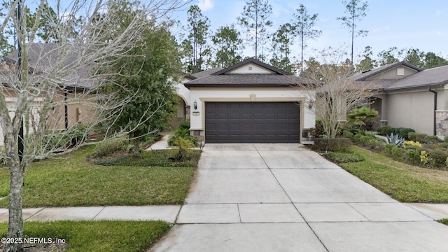 view of front of property with a front yard and a garage