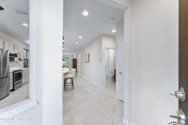 hall with light tile patterned flooring