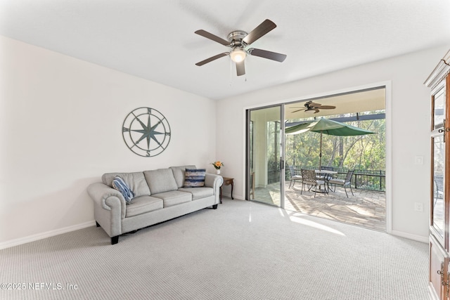 carpeted living room with ceiling fan