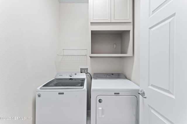 clothes washing area featuring washer and dryer