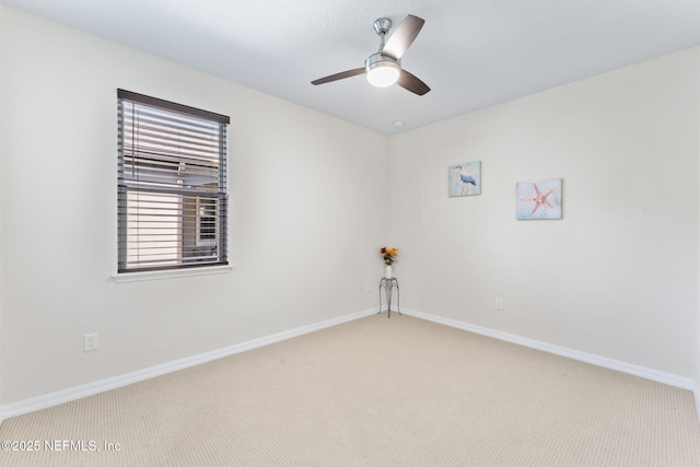 unfurnished room featuring ceiling fan and carpet floors