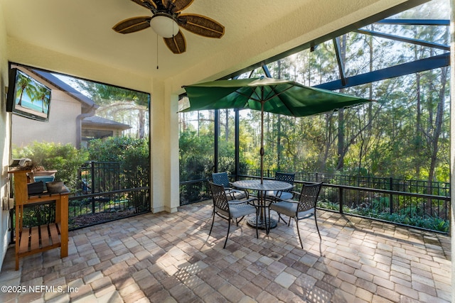 sunroom featuring ceiling fan