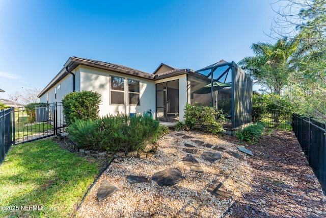 rear view of property featuring a lanai