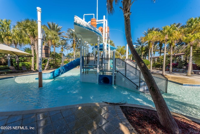 view of swimming pool featuring a playground