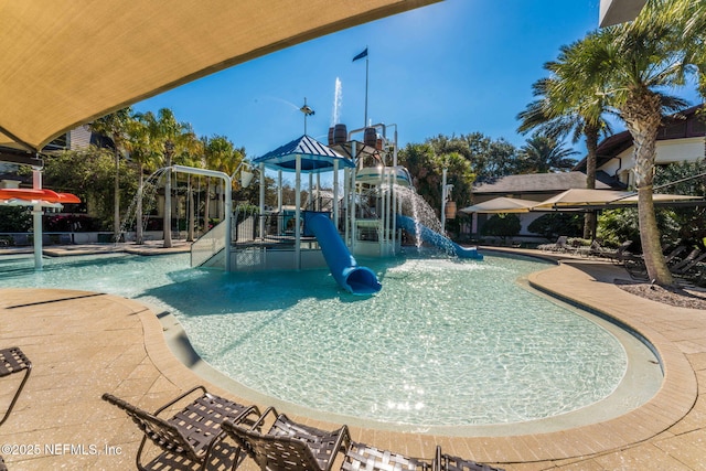 view of jungle gym featuring pool water feature and a community pool