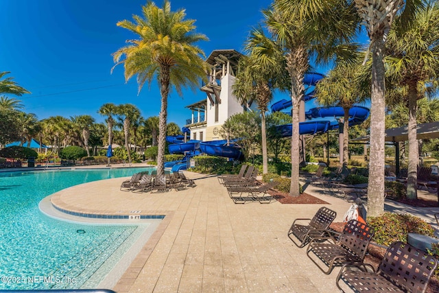 view of swimming pool featuring a patio and a water slide