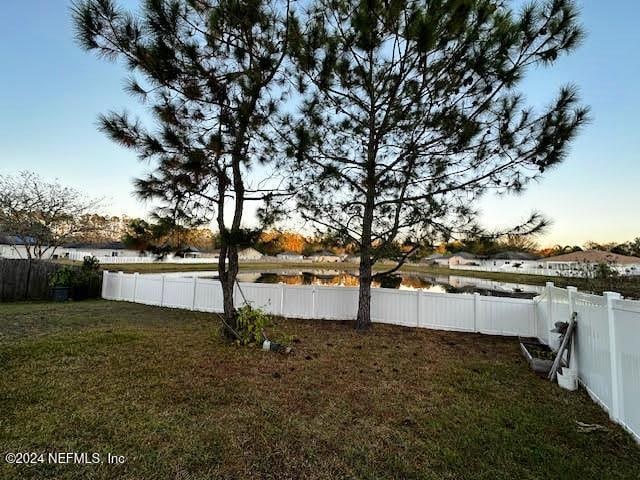 yard at dusk with a water view