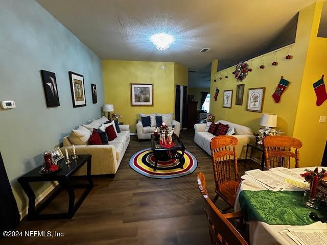 living room with dark hardwood / wood-style flooring