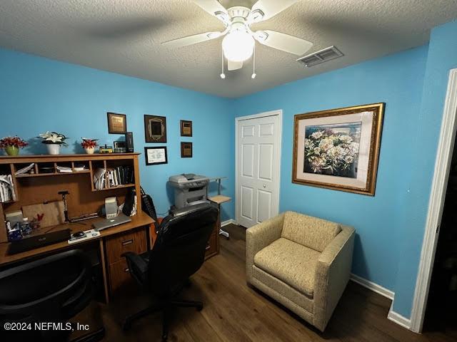 office space featuring a textured ceiling, ceiling fan, and dark wood-type flooring