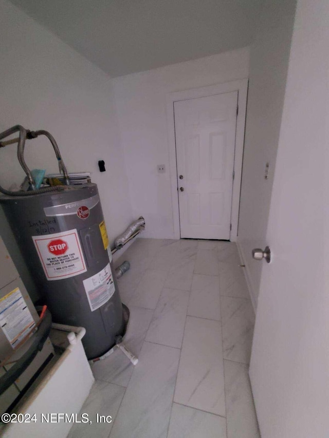 utility room featuring water heater