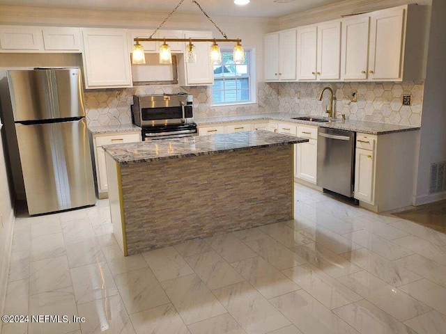 kitchen featuring a center island, sink, decorative light fixtures, light stone counters, and stainless steel appliances