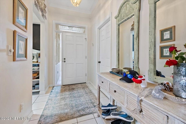 entrance foyer with light tile patterned floors and ornamental molding