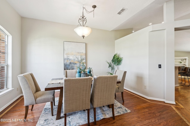 dining space with wood-type flooring