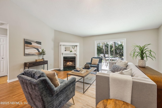 living room with lofted ceiling and light wood-type flooring