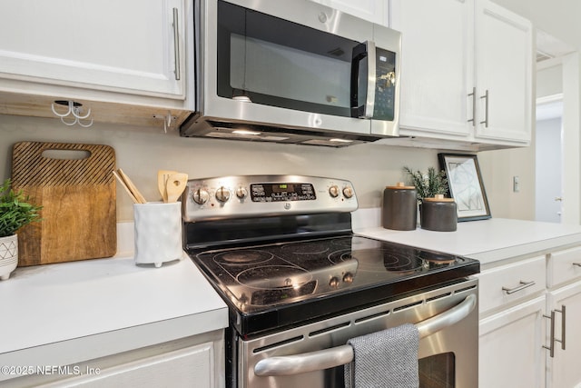 kitchen with white cabinets and appliances with stainless steel finishes