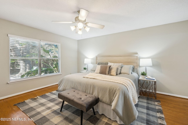 bedroom with hardwood / wood-style flooring and ceiling fan