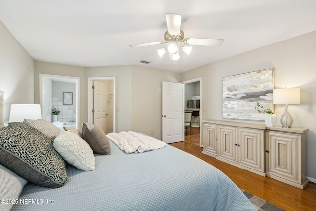 bedroom with wood-type flooring, ensuite bath, and ceiling fan