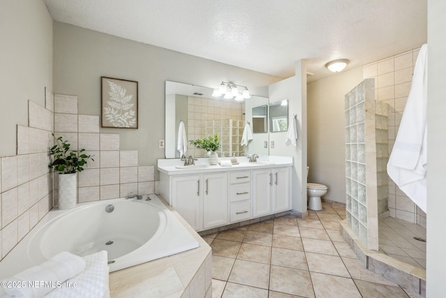 full bathroom featuring vanity, tile patterned flooring, toilet, shower with separate bathtub, and a textured ceiling