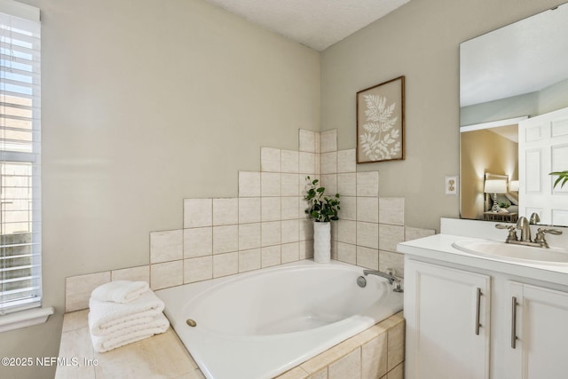 bathroom with vanity and a relaxing tiled tub