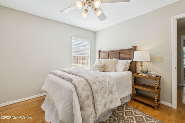 bedroom with hardwood / wood-style flooring and ceiling fan