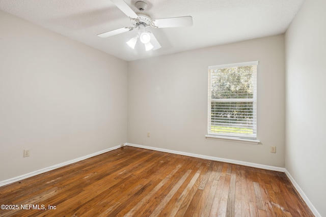 empty room featuring ceiling fan and hardwood / wood-style floors