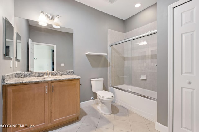 full bathroom with tile patterned flooring, vanity, toilet, and bath / shower combo with glass door