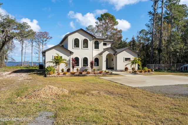 mediterranean / spanish-style home featuring a front lawn