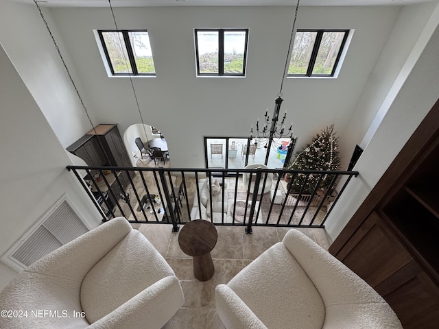 stairway featuring a towering ceiling