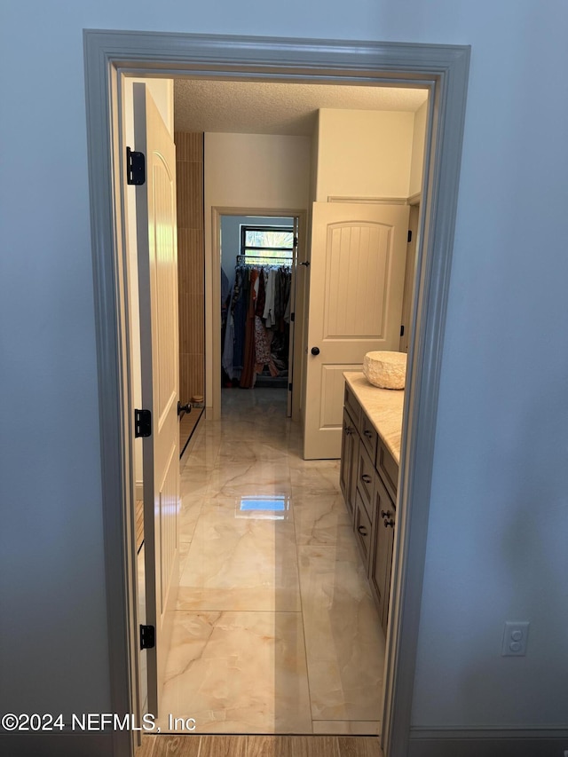 bathroom with vanity and a textured ceiling