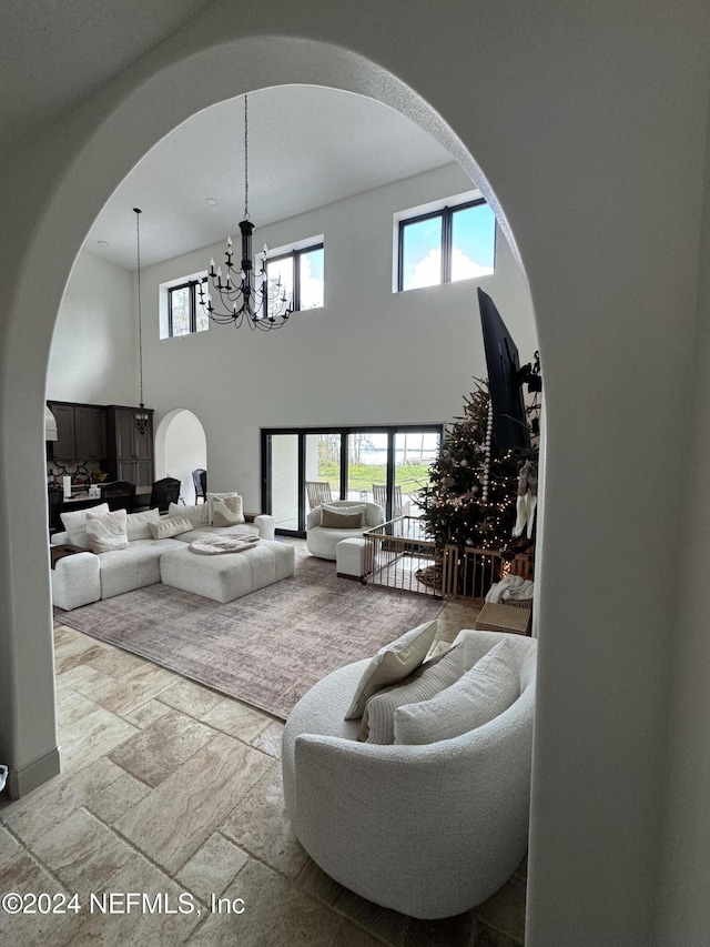 living room featuring a chandelier and a high ceiling