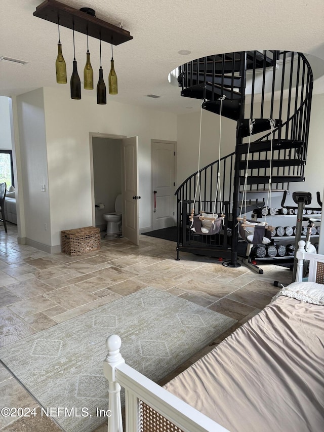 staircase with a textured ceiling