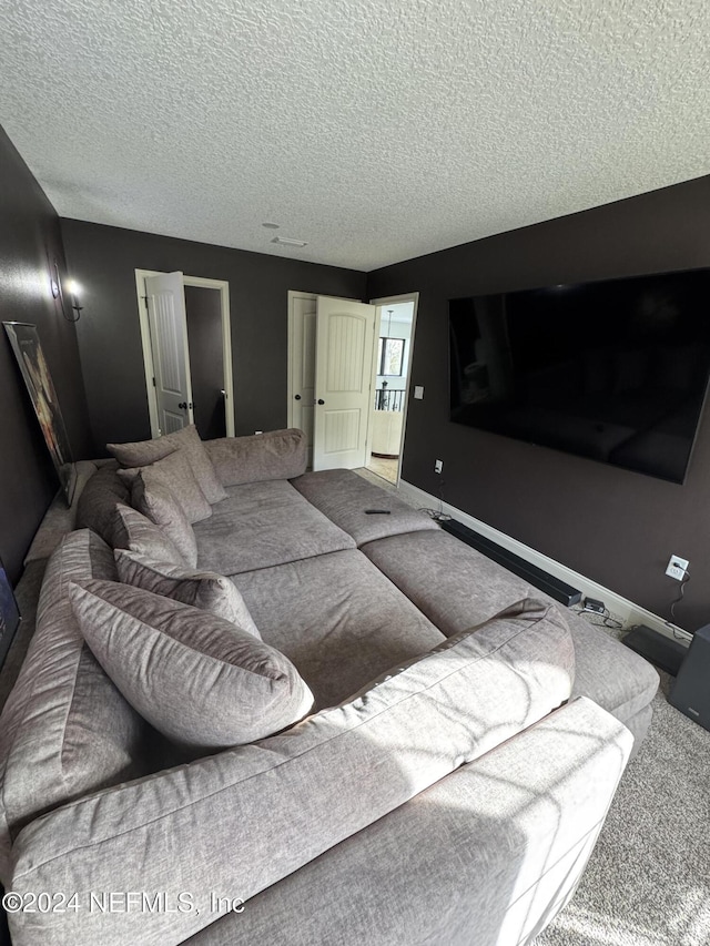 living room with carpet floors and a textured ceiling