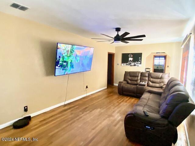 living room featuring hardwood / wood-style floors and ceiling fan