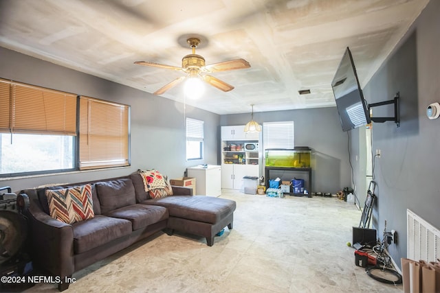 living room with a wealth of natural light and ceiling fan