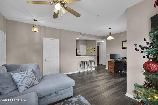 living room with ceiling fan and dark hardwood / wood-style flooring